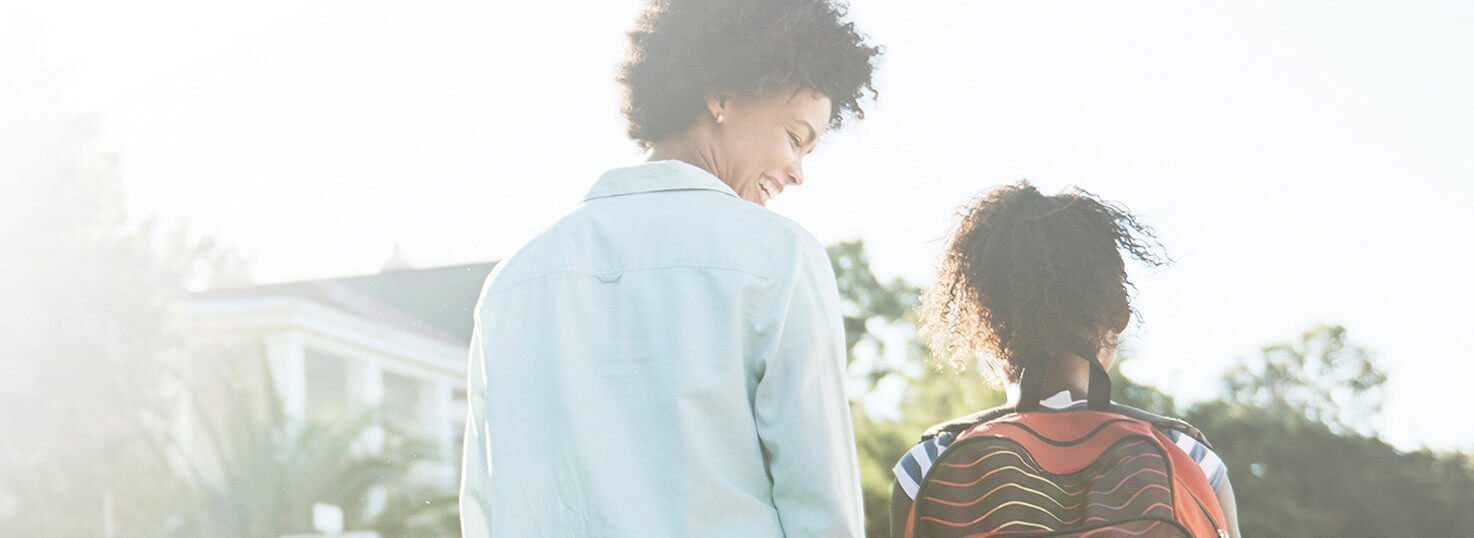 This is an image of a mom and daughter walking together