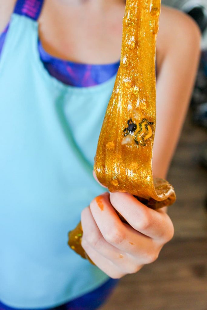 This is an image of a girl holding golden honey slime